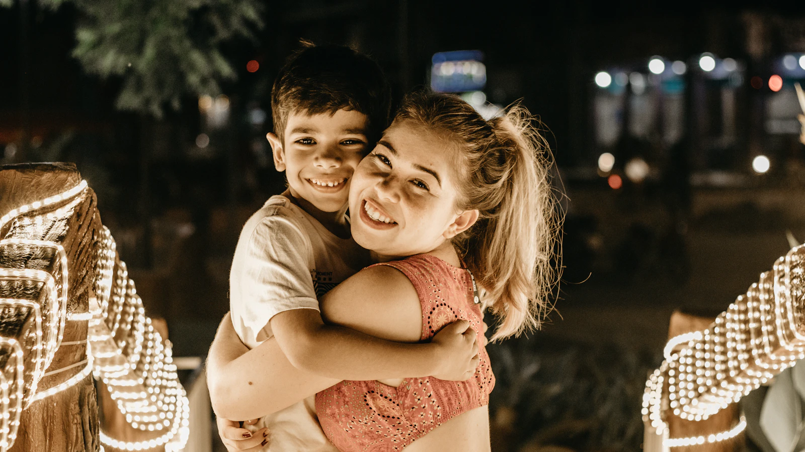 A mother hugging her smiling daughter