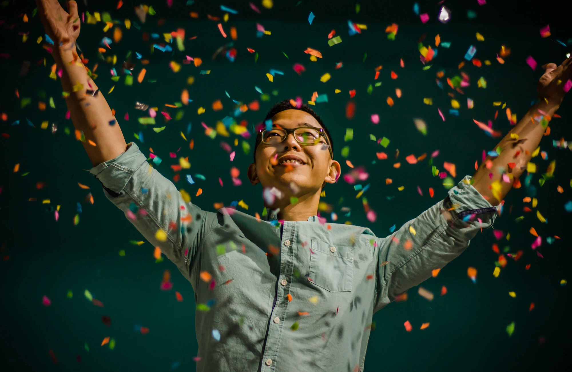 A founder celebrating under falling confetti