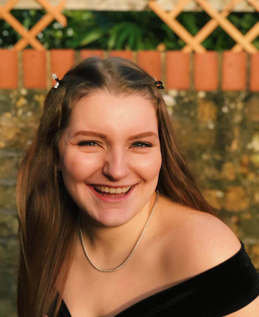 A smiling founder in warm sunlight