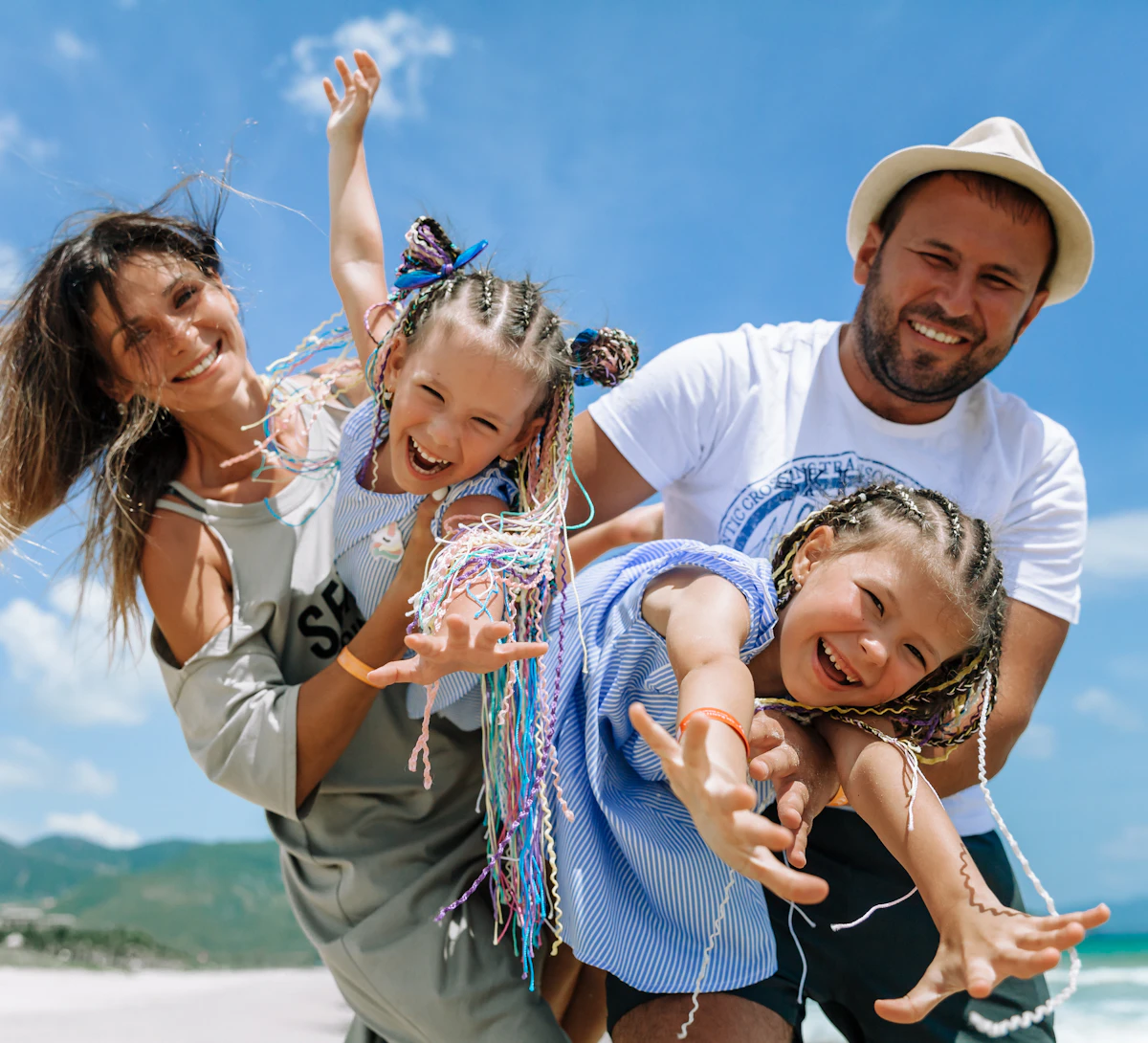 A happy family jumping on the beach