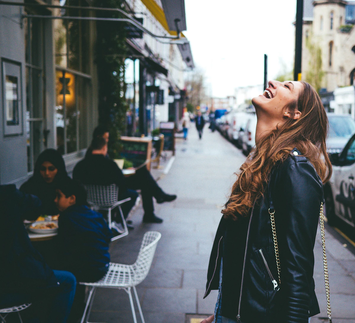 A founder laughing on a city street