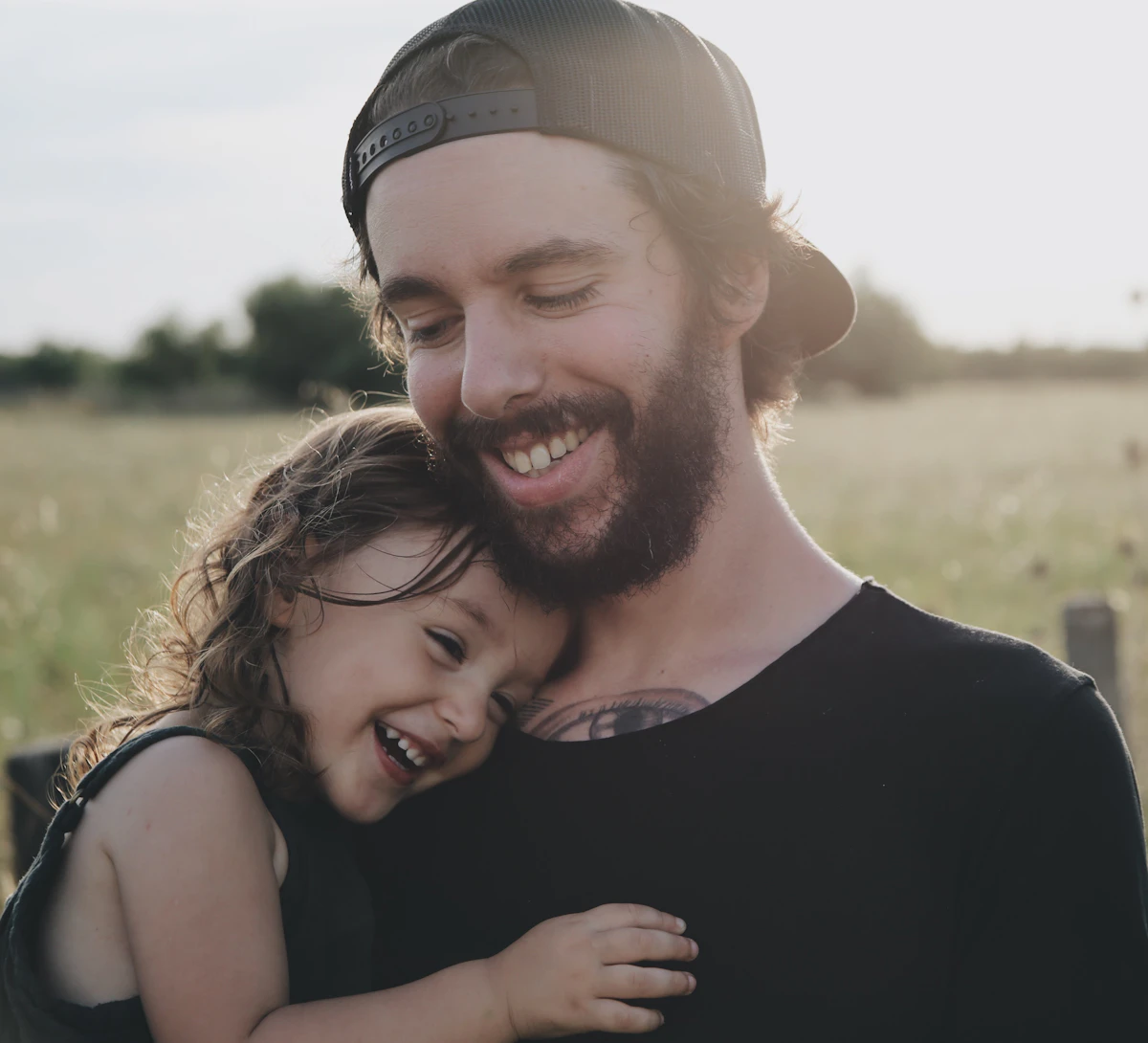 A father hugging his smiling daughter